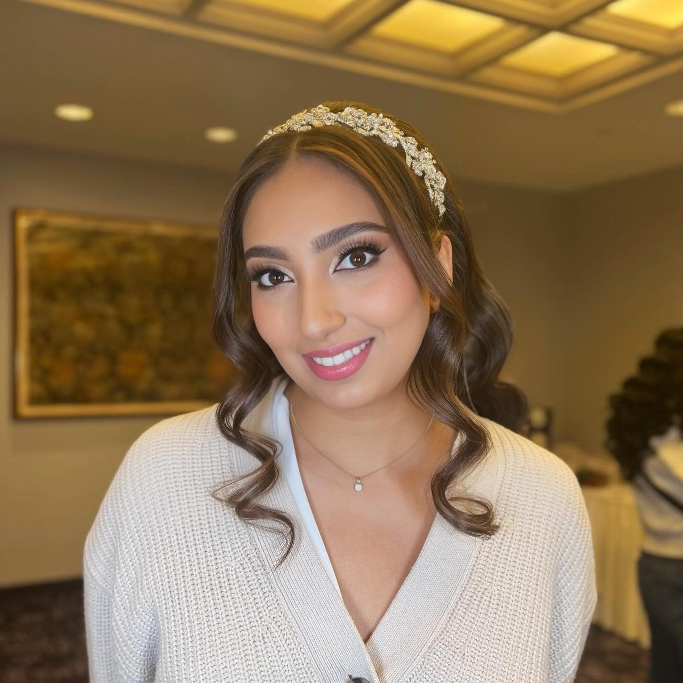 Bride with natural glam makeup, soft waves, and a crystal headpiece